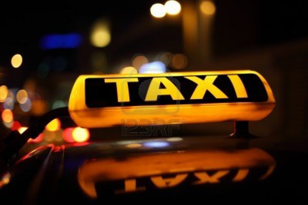 10115486-yellow-taxi-sign-at-night